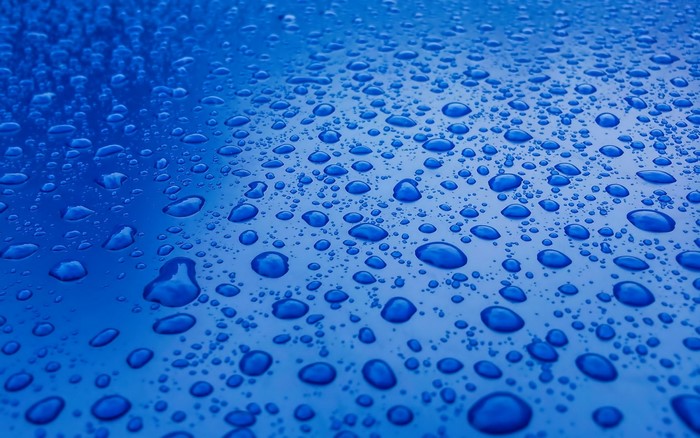 Blue surface with many water drops