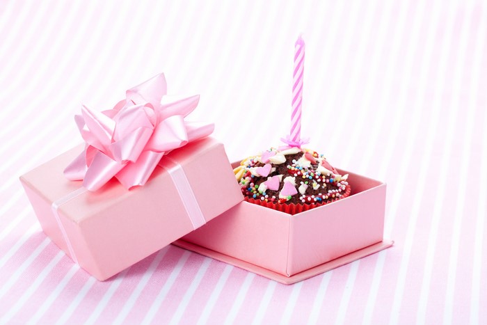 Pink gift box with cupcake and candle