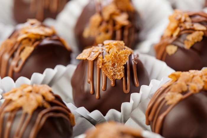 Chocolate candies with caramel drizzle and nuts