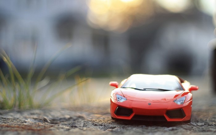 Orange toy sports car on the ground