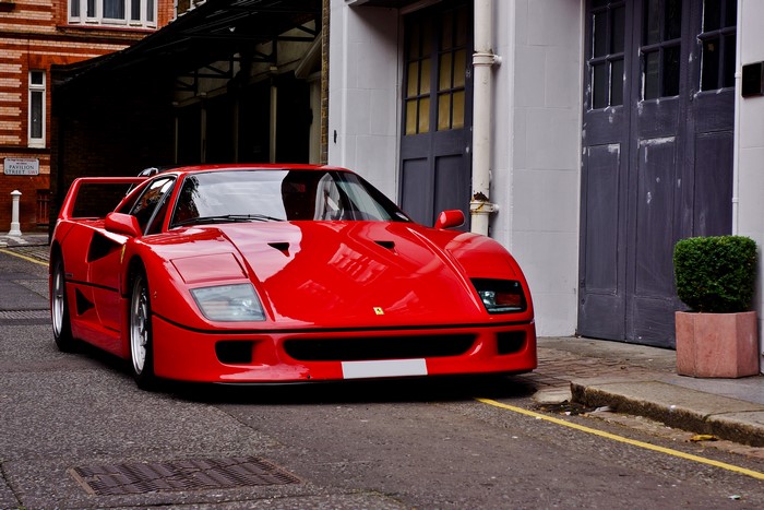 Red Ferrari F40 parked on a street