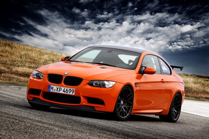 Orange BMW M3 Coupe on a Racetrack
