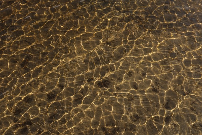 Sunlight patterns on shallow water