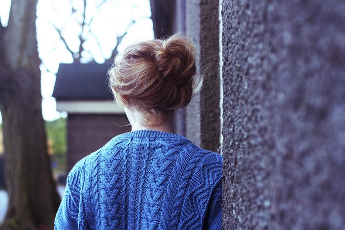 Woman wearing a blue cable knit sweater
