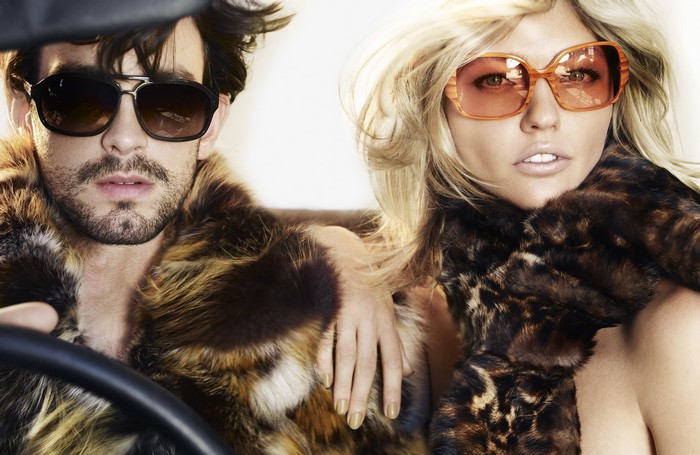Man and woman in fur coats and sunglasses