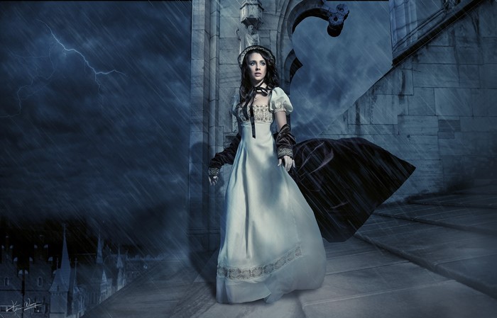 Woman in a white dress in the rain at night