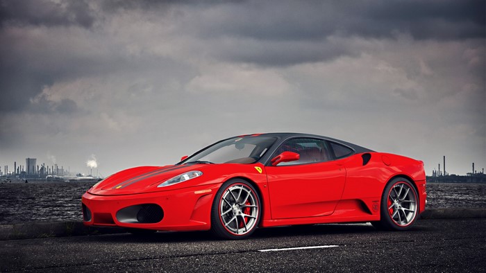 Red Ferrari F430 parked by the water