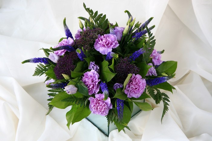 Purple and blue flowers in a glass vase