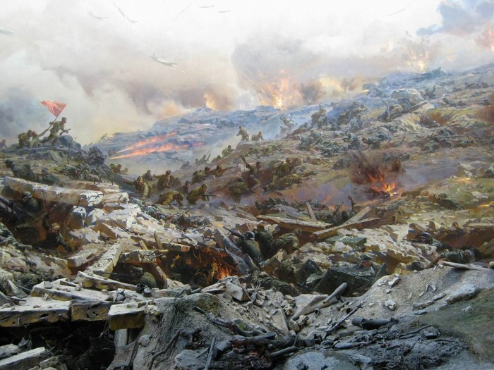 Soldiers in a chaotic battle scene with explosions and aircraft