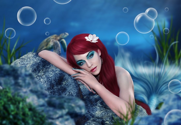 Mermaid with red hair underwater