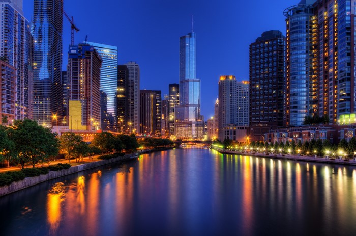 Chicago city skyline at night with river reflections