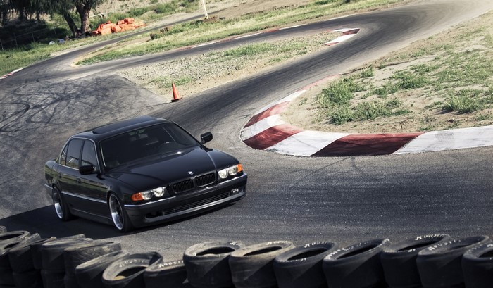 Black BMW 740i E38 on a race track