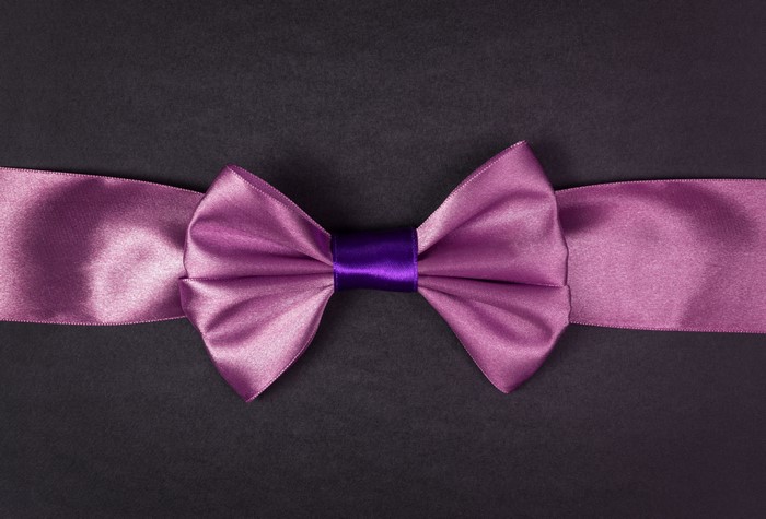Violet bowknot on a dark background