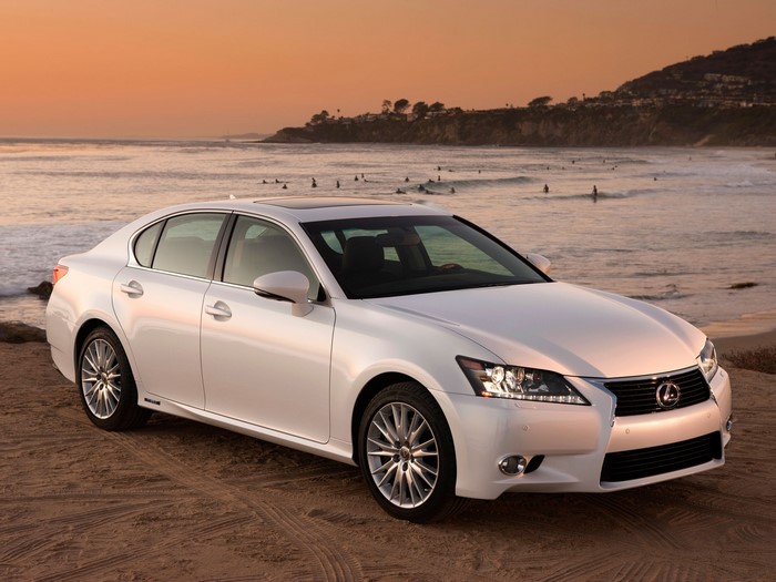 White Lexus GS450h parked on a beach at sunset