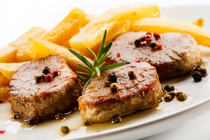 Meat medallions with french fries and rosemary
