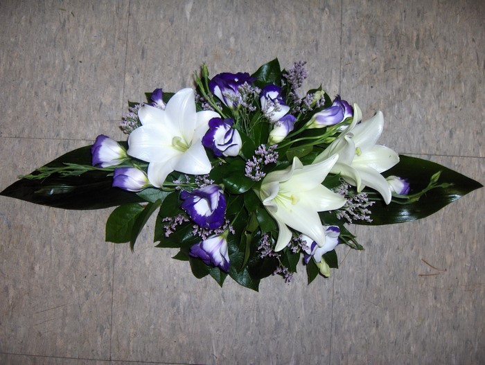 White lilies and purple lisianthus floral arrangement