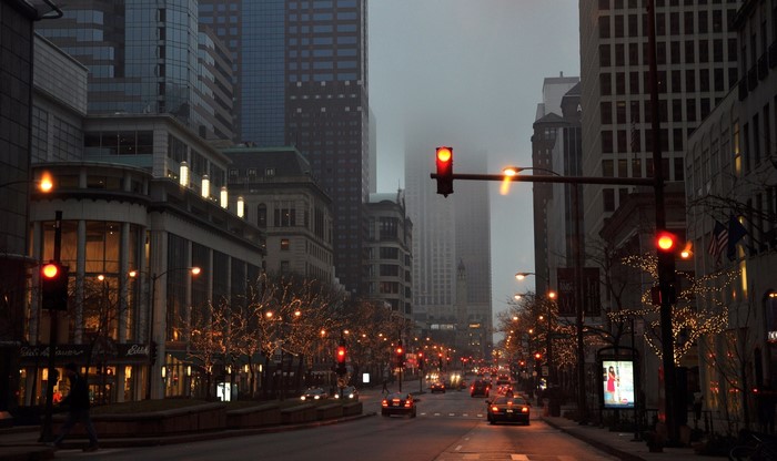Chicago street at dusk with traffic and city lights