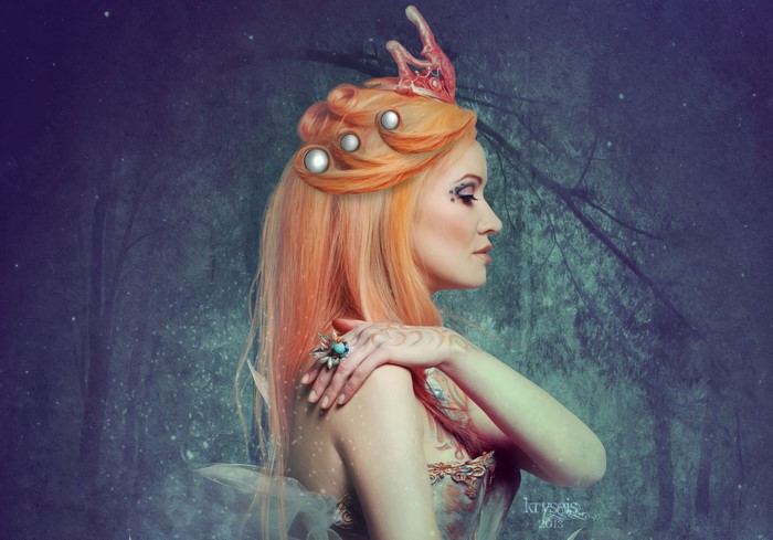 Redhead girl with crown in forest