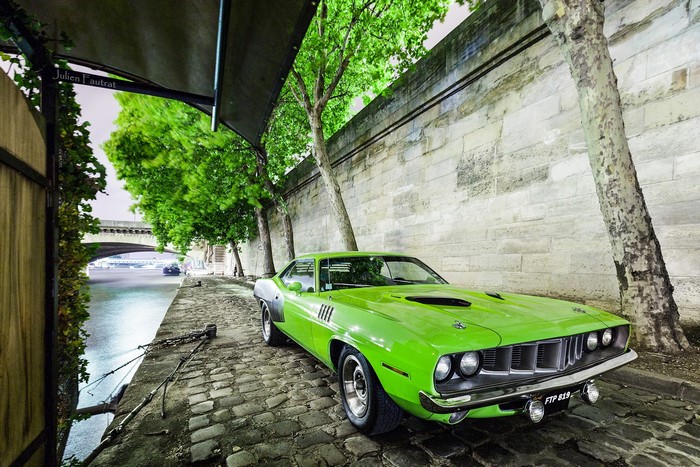 1971 Plymouth Barracuda parked by a river in Paris
