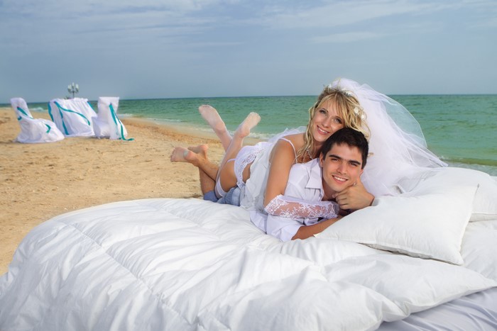 Bride and Groom on a Bed at the Beach