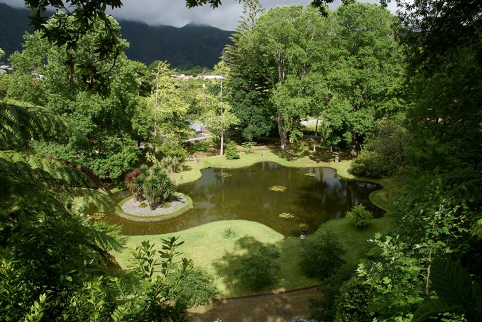 Terra Nostra Park pond with island and mountains