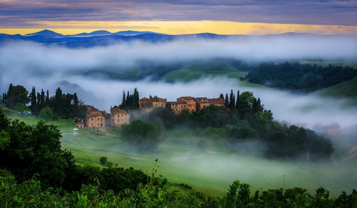 Tuscan village in fog at sunrise, Vergelle, Italy
