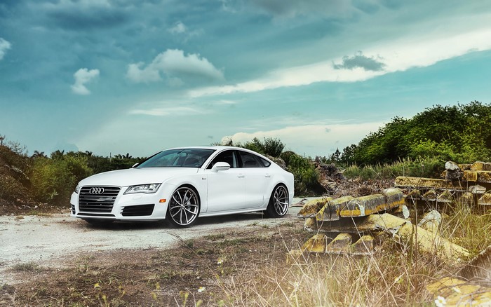 White Audi A7 parked on a dirt road