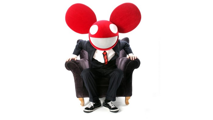 Deadmau5 in a suit sitting in an armchair