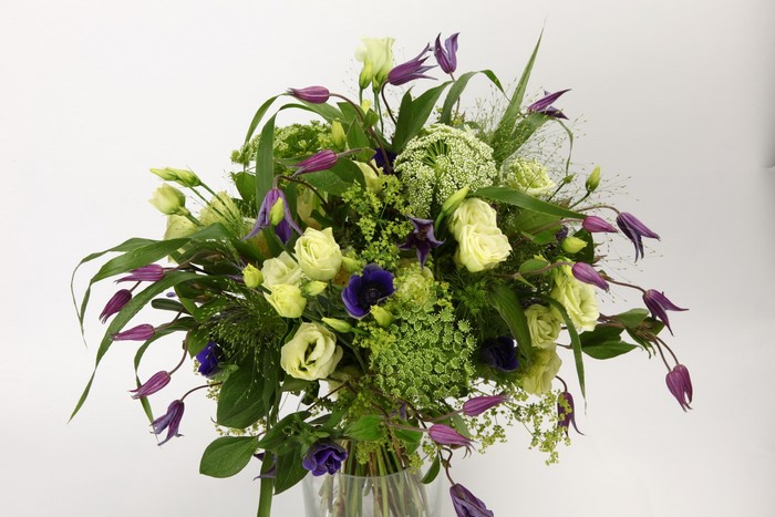 Bouquet of white roses and purple clematis