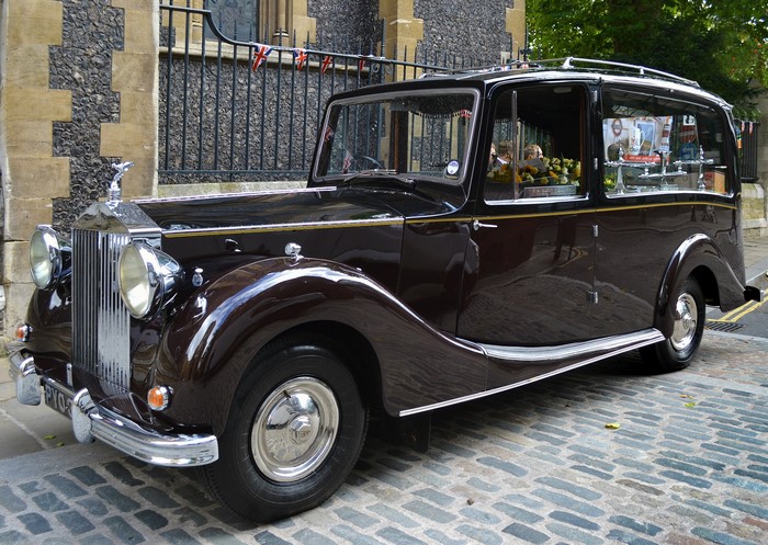 Rolls-Royce hearse parked on cobblestone street