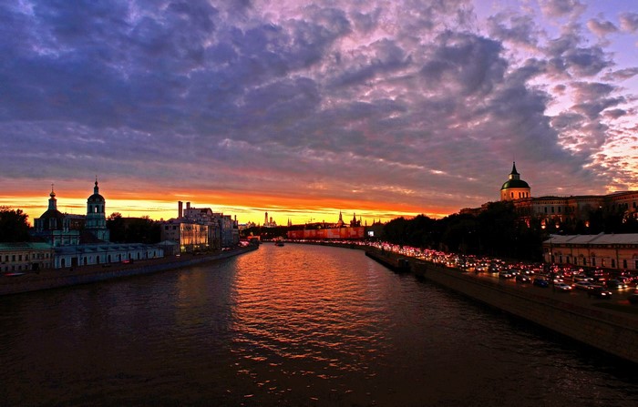 Moscow River at sunset with Kremlin and traffic