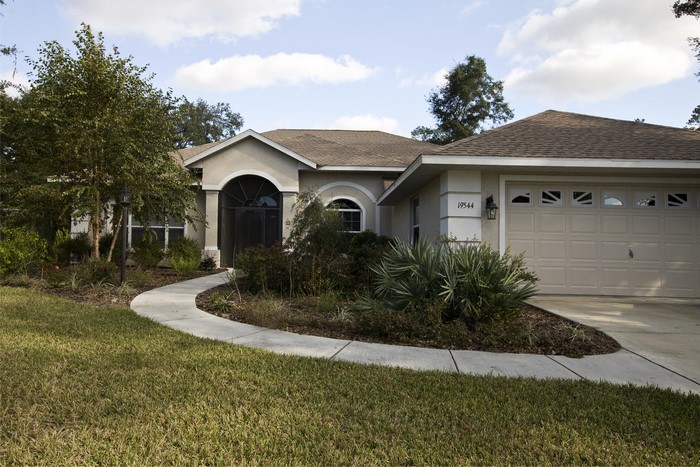Single-story house with a garage and curved walkway