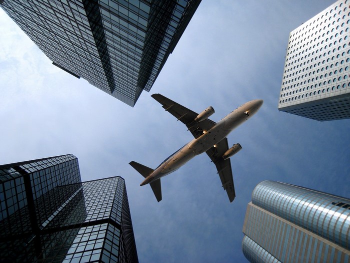 Airplane flying between skyscrapers in Hong Kong