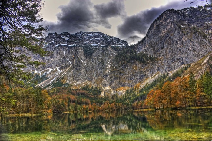 Lake reflection of mountains and autumn trees in Gmunden, Austria