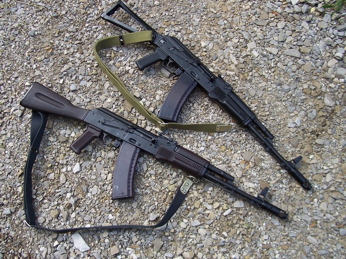 Two AK-74 assault rifles on gravel