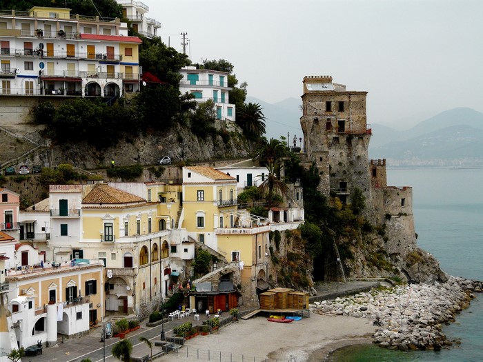 Houses and castle on a cliff overlooking the sea in Italy