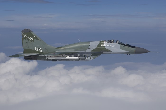 Mikoyan MiG-29 fighter jet flying above clouds