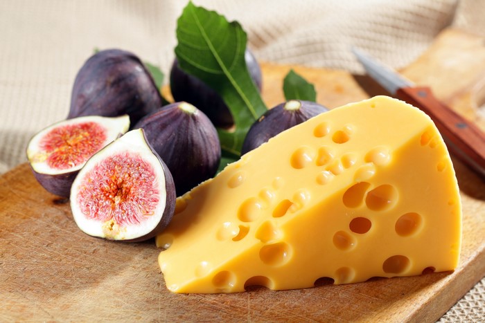 Cheese and figs on a wooden board