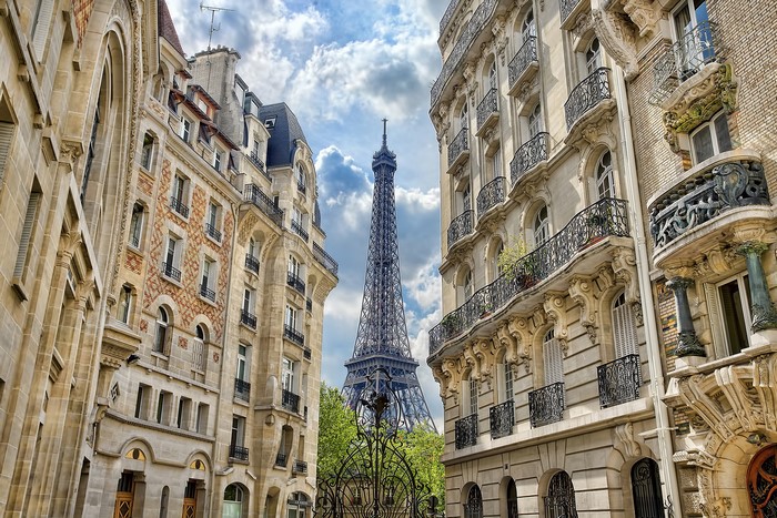 Eiffel Tower viewed between Parisian buildings