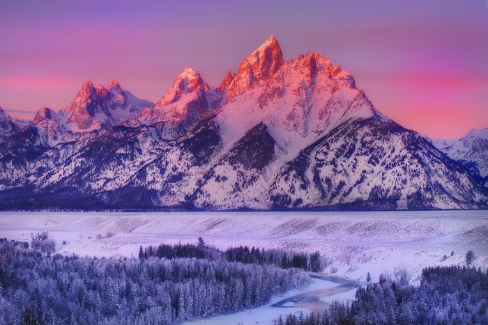 Snow-covered Grand Teton mountains at sunrise