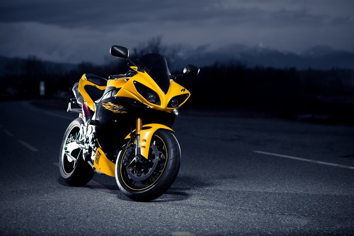 Yellow Yamaha R1 motorcycle at night on asphalt