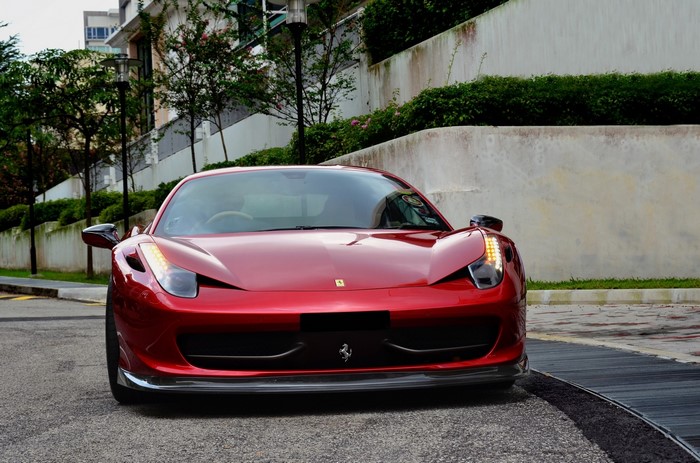 Red Ferrari 458 Italia parked on a street