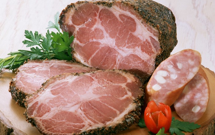 Sliced cured meat and sausage with herbs