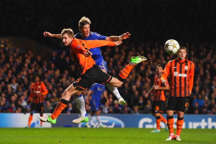 Football players jumping for a ball