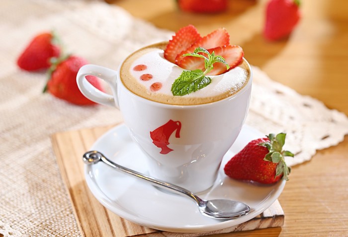 Strawberry latte with whipped cream and mint