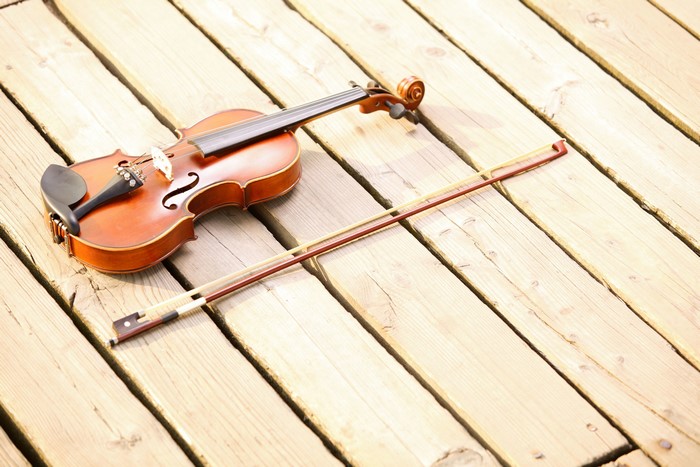 Violin and bow on wooden planks