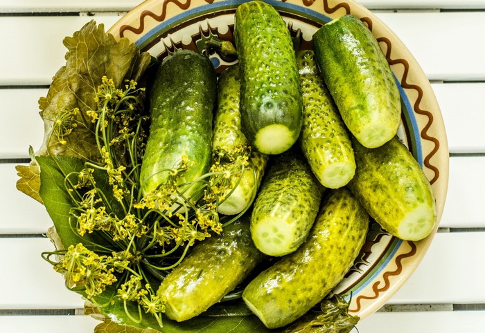 Pickled Cucumbers with Dill and Leaves in a Bowl