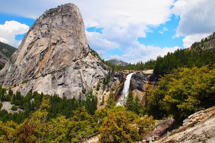 Waterfall and large rock formation in Yosemite National Park, California