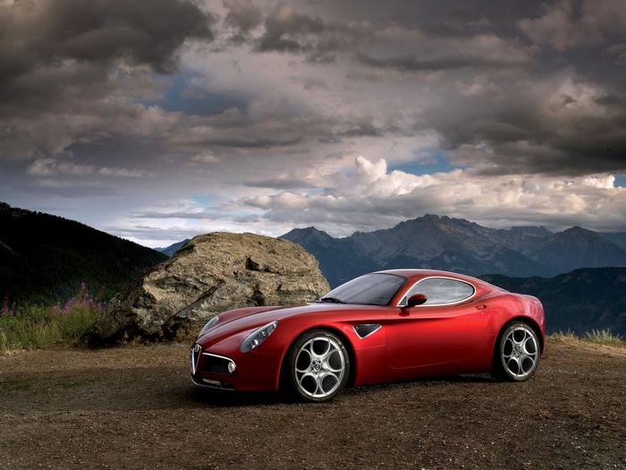 Red Alfa Romeo 8C Competizione in mountains