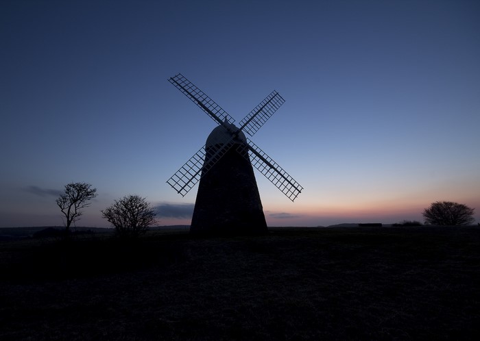 Silhouette of a windmill at dusk